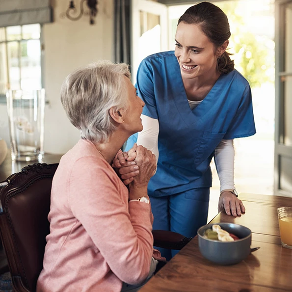 Caregiver assisting elderly woman at home with compassionate in-home senior care